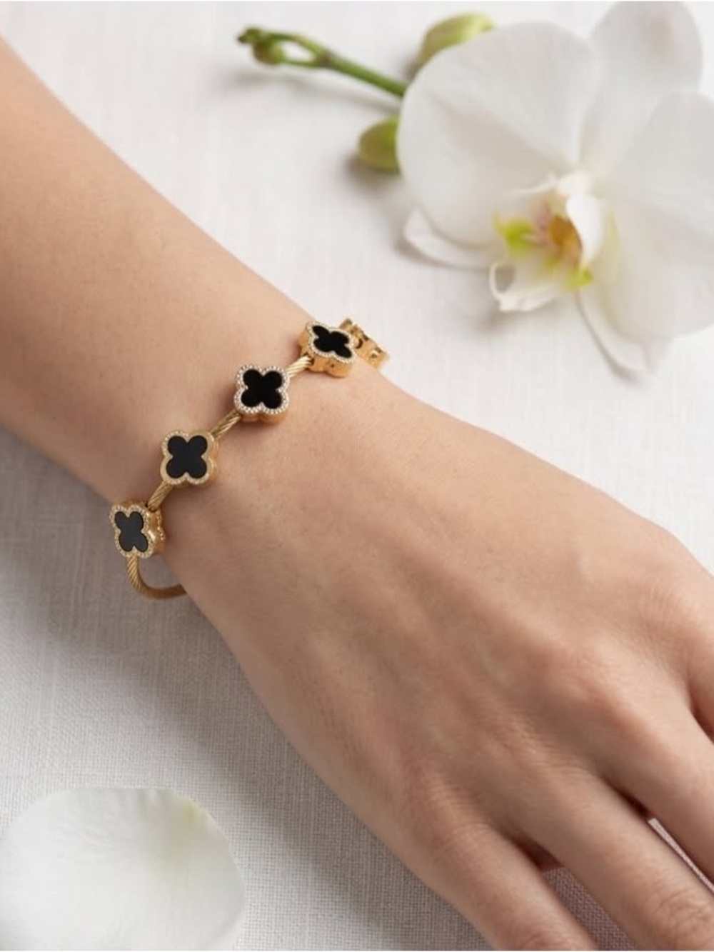 Gold Bracelet with Black Clover Accents - Elegant Women's Jewelry